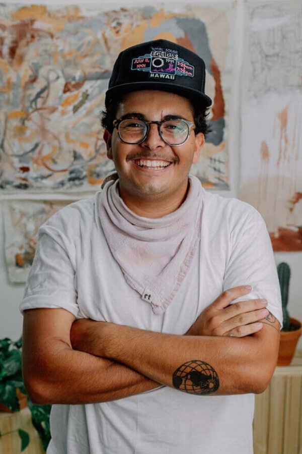 Creative man standing in front of painting